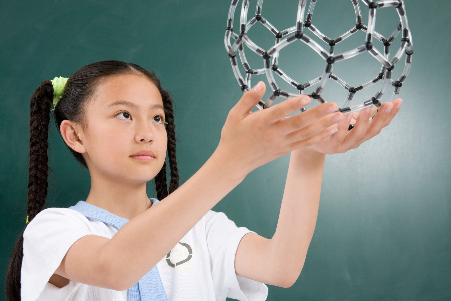 A girl holding a science model