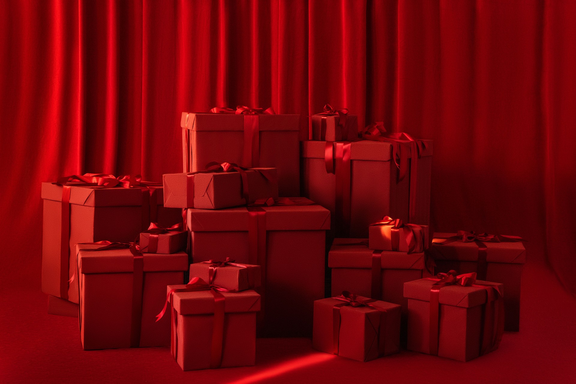 Large gift boxes with a bow on a red background